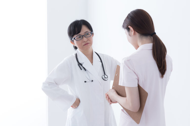 Two healthcare professionals in discussion, highlighting conflict resolution in healthcare.