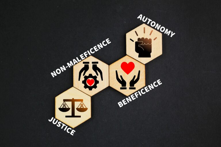 Four core principles of nursing ethics—autonomy, beneficence, non-maleficence, and justice—illustrated with icons on wooden hexagons.