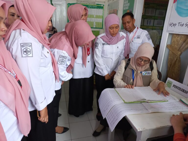 Healthcare workers reviewing records at a Puskesmas demonstrate patient safety in primary care in Indonesia through documentation and team coordination.